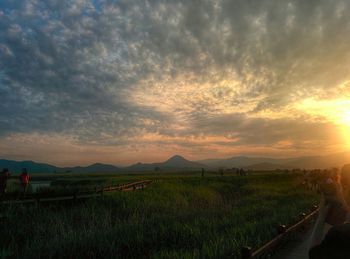 Scenic view of landscape against cloudy sky