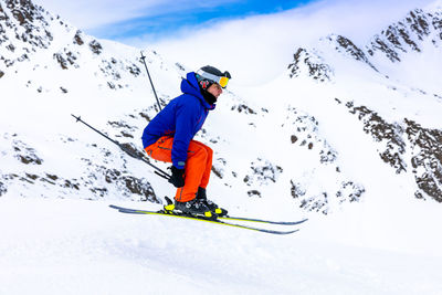 Man skiing on snowcapped mountain during winter