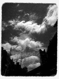Low angle view of building against cloudy sky