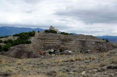 Ruins of building against cloudy sky