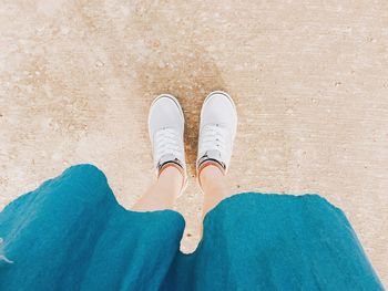 Low section of woman standing on footpath