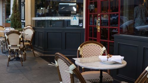 Empty chairs and tables outside cafe