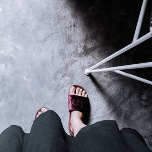 Low section of woman wearing canvas shoes