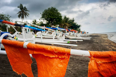 Close-up of clothes hanging on beach against sky