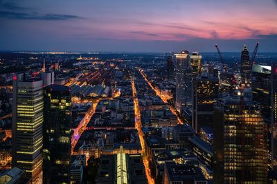 High angle view of illuminated buildings against sky at sunset