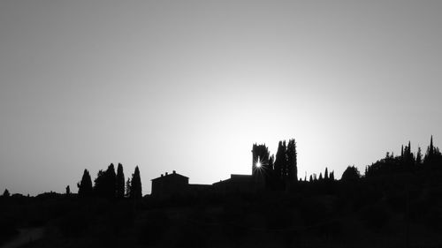 Silhouette built structures against clear sky