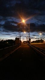 Empty road against cloudy sky