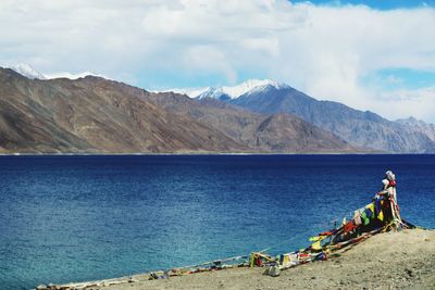 Scenic view of lake against cloudy sky