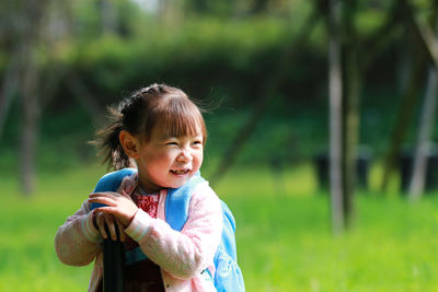 Smiling cute girl standing in park