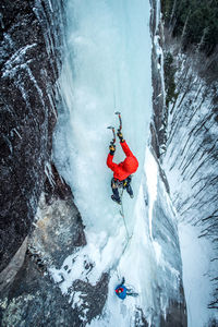 Person skiing on rock in snow