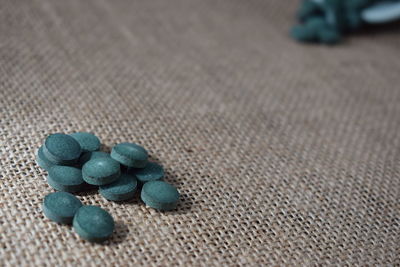 Close-up of pills on jute