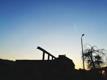 Low angle view of silhouette built structure against sky