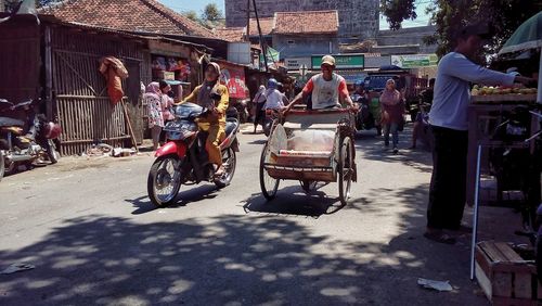 People riding bicycles on street in city