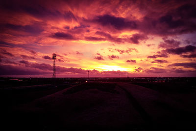 Silhouette landscape against sky during sunset