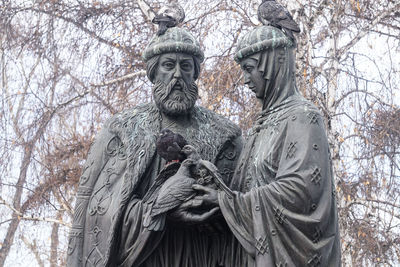 Low angle view of statue against bare trees