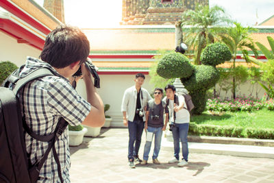 Rear view of people walking outdoors