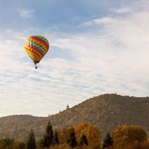 Hot air balloon flying over clouds