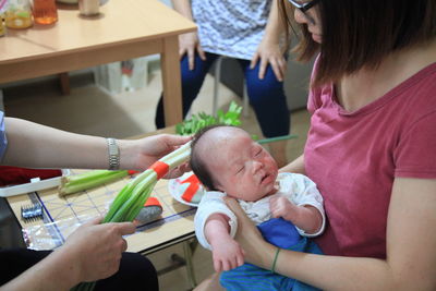 Mother holding baby boy at home