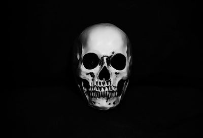 Close-up of human skull against black background