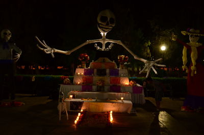 Illuminated sculpture against sky at night