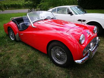 Red vintage car on field