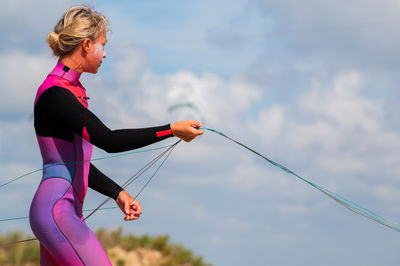 Full length of woman exercising on field