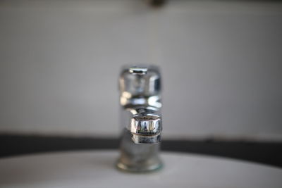 Close-up of water faucet on table