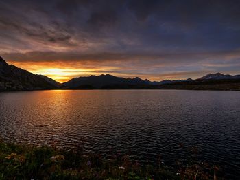 Scenic view of lake against sky during sunset