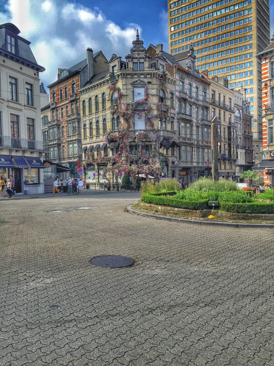 architecture, building exterior, built structure, city, street, large group of people, surface level, outdoors, city life, travel destinations, person, sky, tourism, day, vacations, facade, in front of, town square, old town