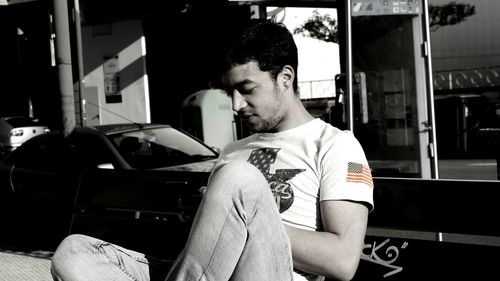 Young man sitting on table