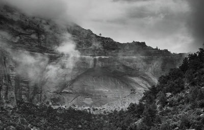 Scenic view of land against cloudy sky