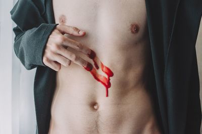 Close-up of hand on red fabric