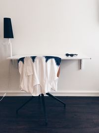 Laundry drying against white wall at home