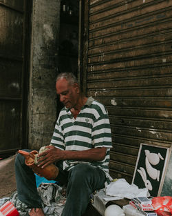 Vendor sitting by shutter