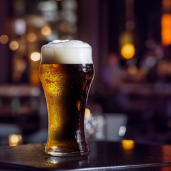 Close-up of beer glass on table