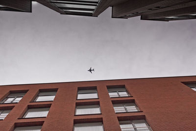 Low angle view of airplane flying in sky