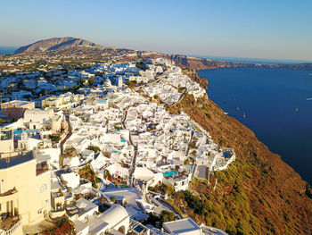 High angle view of townscape by sea against sky