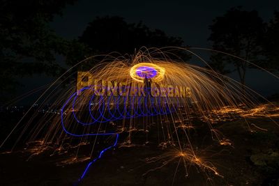 Light trails against sky at night