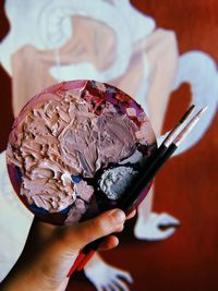 Close-up of hand holding ice cream