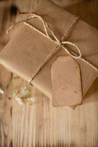 Festively wrapped gift in kraft paper with a tag for wishes