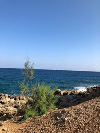 Scenic view of sea against clear blue sky