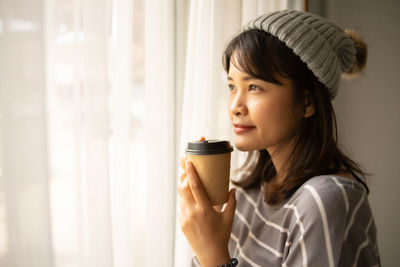 Portrait of woman drinking water