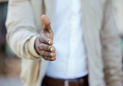 Midsection of couple holding hands