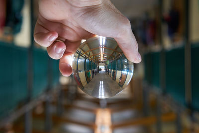 Close-up of human hand holding crystal ball in stable