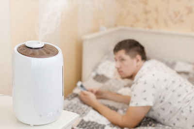 Humidifier spreading steam. humidification of the dry air in sleeping room. selective focus on vapor