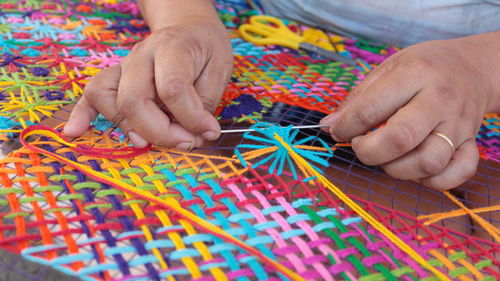 Cropped image of person making crochet