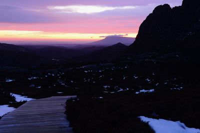 Scenic view of silhouette mountains against sky during sunset
