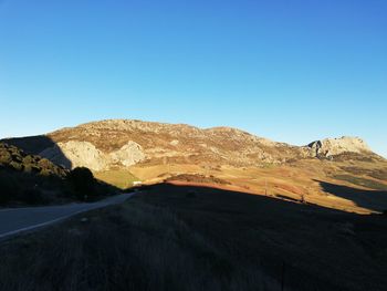 Scenic view of mountains against clear blue sky