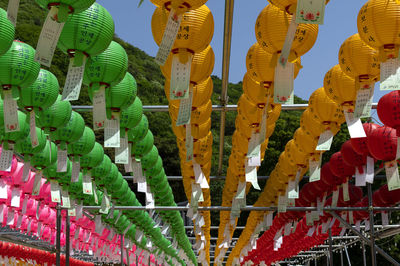 Low angle view of multi colored lanterns hanging against sky