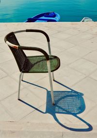 High angle view of empty chair at swimming pool